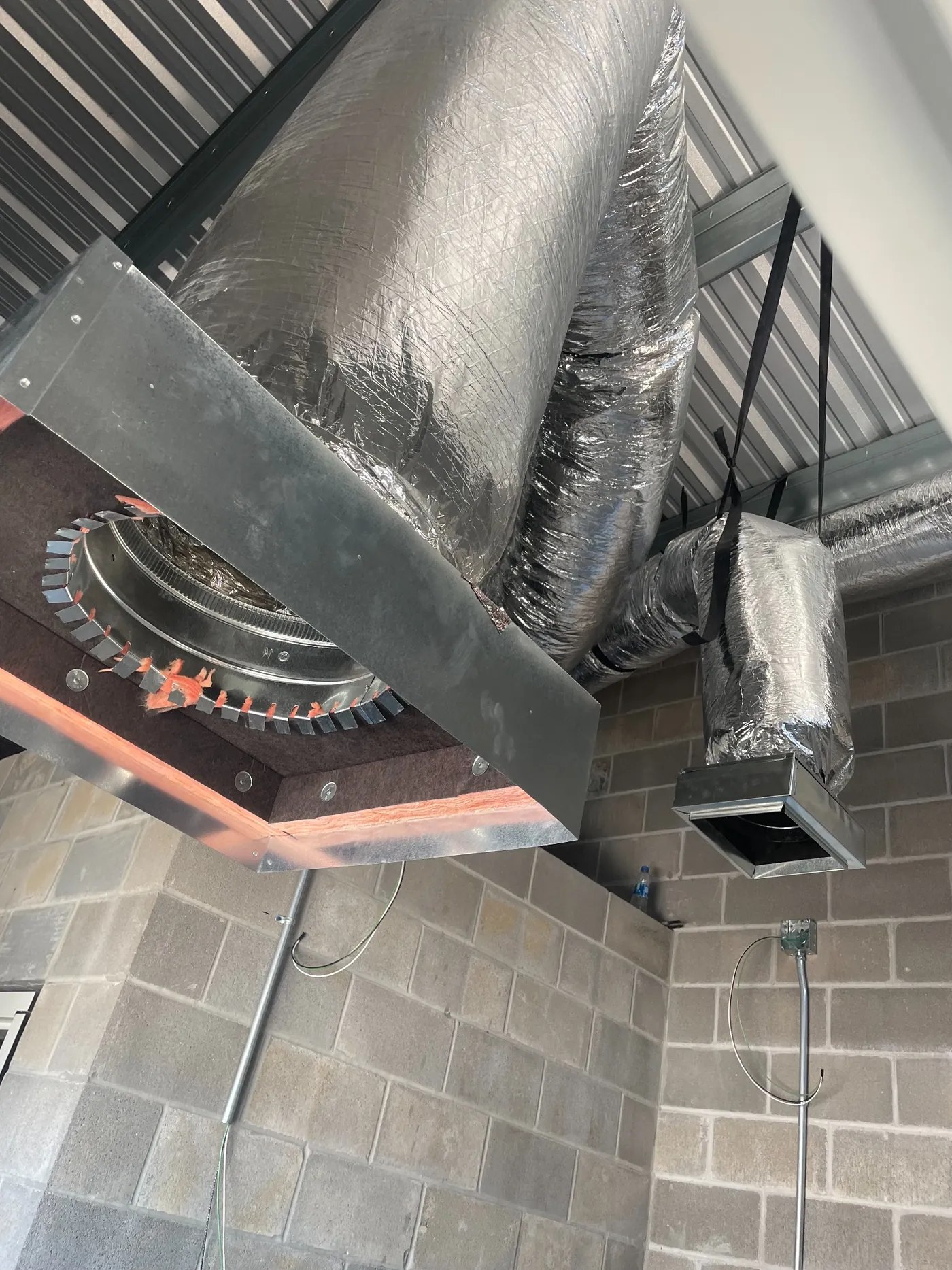 Neighborly team installing commercial HVAC ductwork
